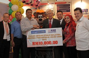 Abd. HALIM ABD. SAMAD (empat kanan) menyerahkan cek replika kepada Mohd. Hassan Mohd. Noor sambil disaksikan Zainal Abideen Salleh (tiga kanan) dan Jamelah A. Bakar pada Majlis Tajaan Akhbar Utusan Malaysia oleh KUB sempena Perhimpunan Agung UMNO 2014 di Kuala Lumpur, semalam. 